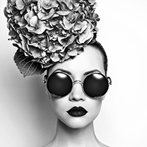 Woman wearing sunglasses with fancy hat
